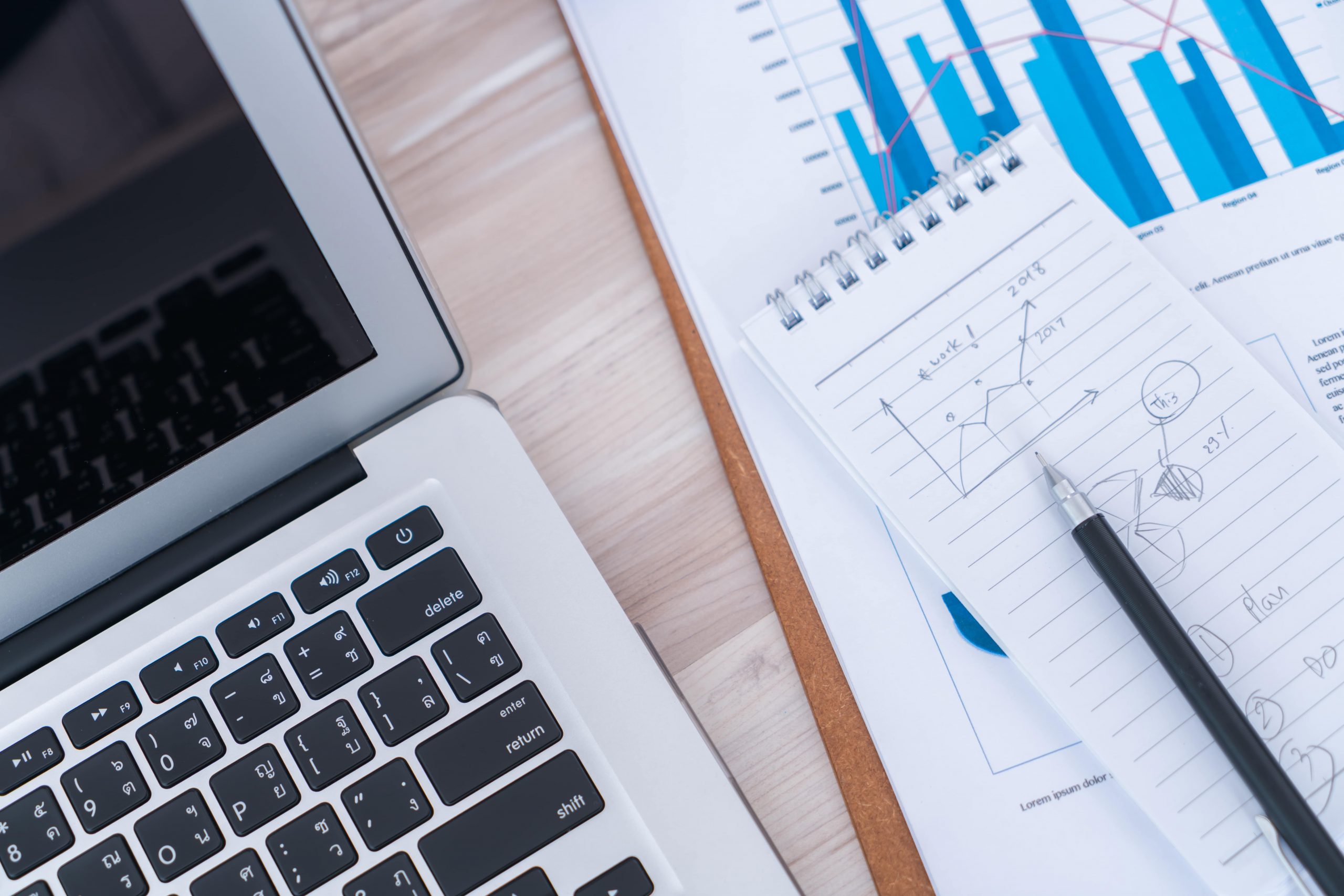 financial-charts-table-with-laptop-min